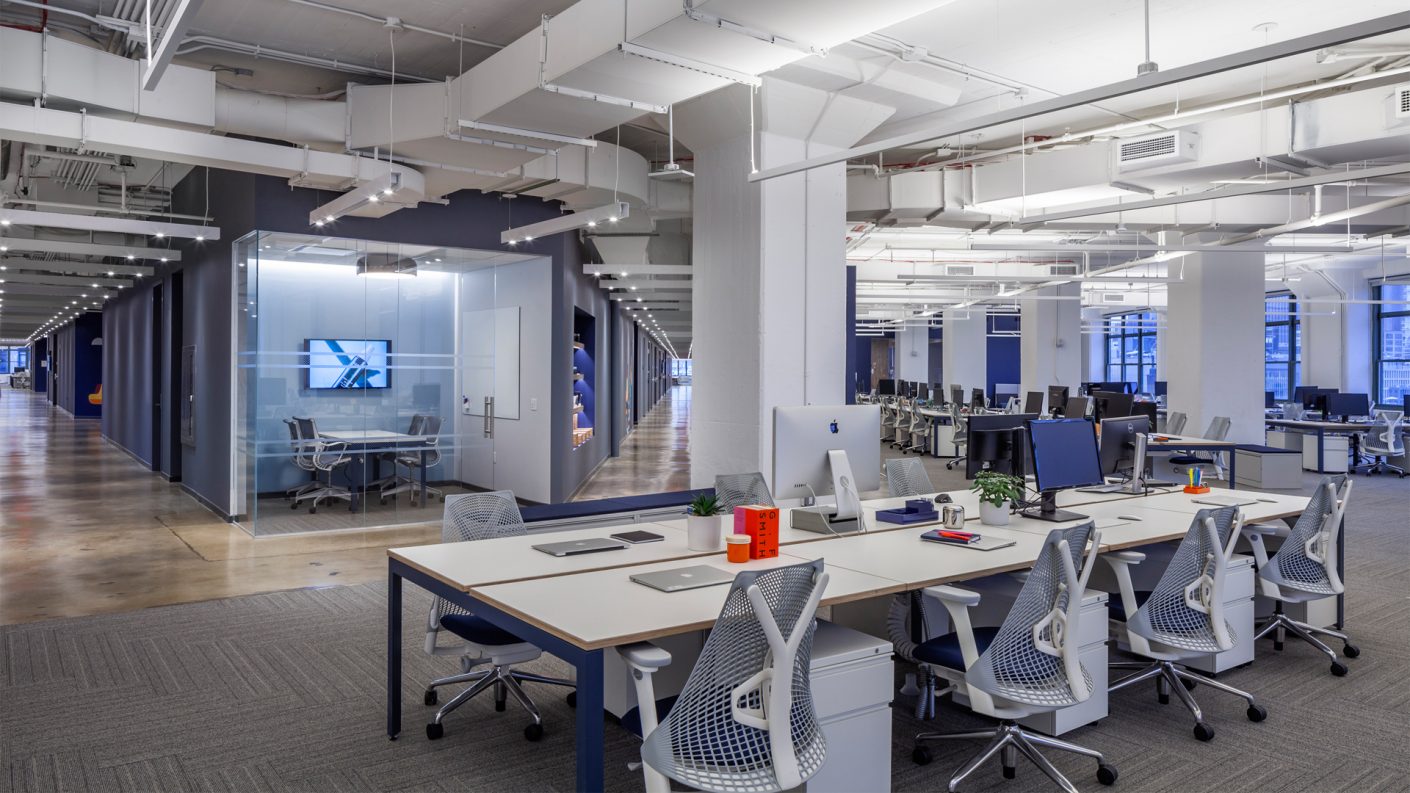 from one corner of a triangular floorplate, two long corridor end in a meeting room, while large open workspaces line the office perimeter