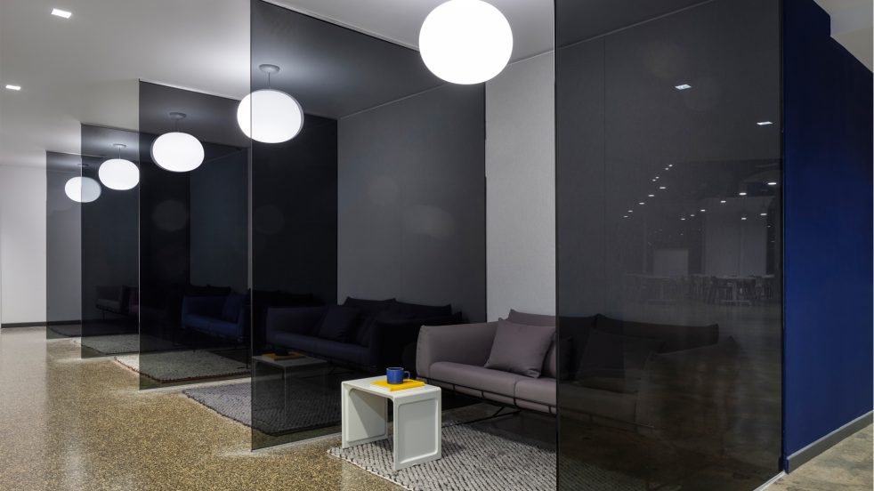 open lounge areas with couches divided by translucent partitions