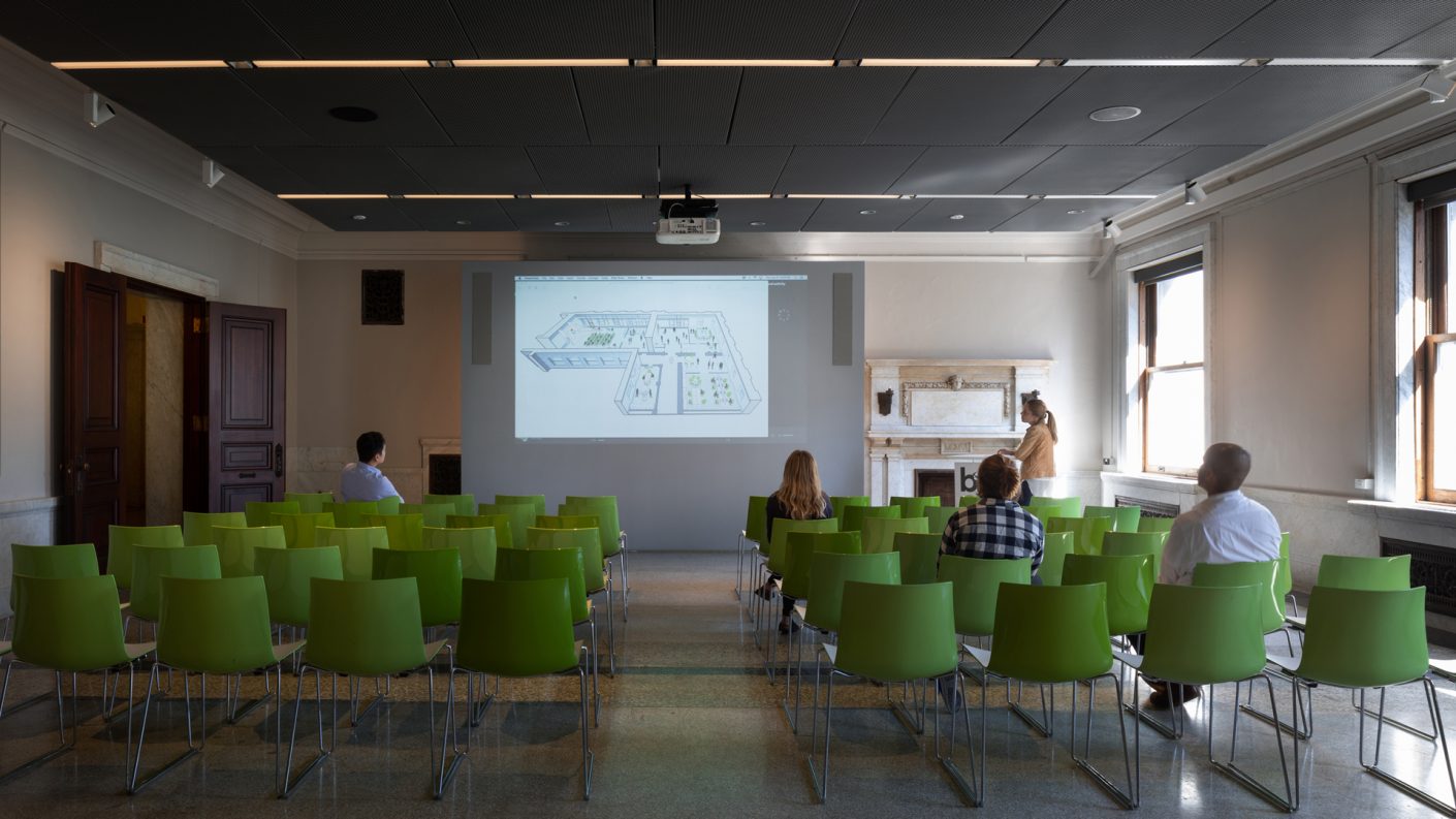classroom with green chairs and display panels