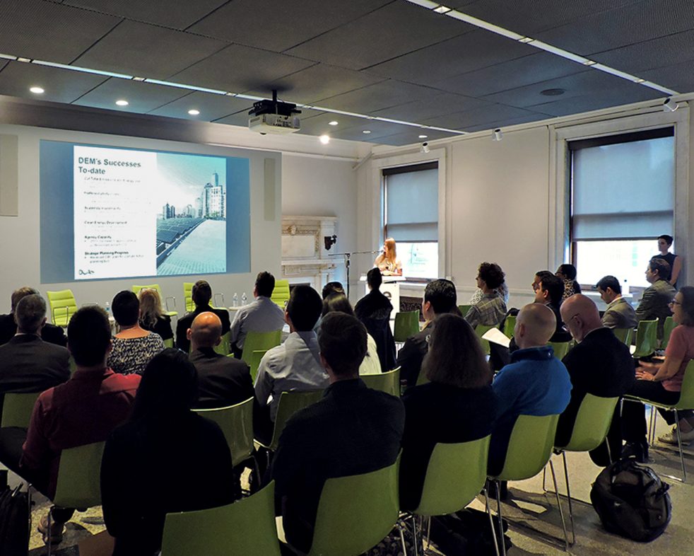 people seated attending a presentation at BE-Ex