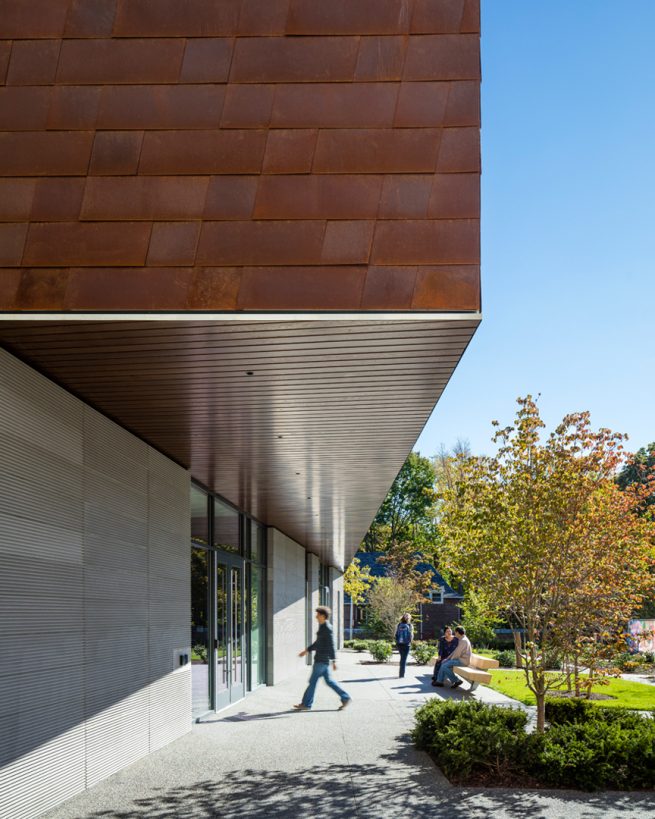 student walks into Applied Math building through the campus-facing entry