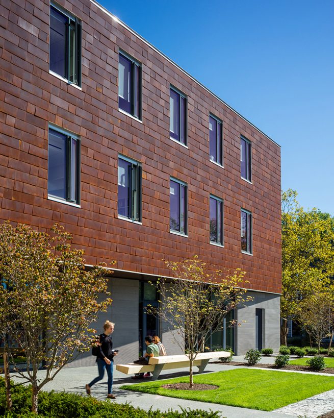 students leave the Applied Math building through the garden rooms from the campus-facing facade