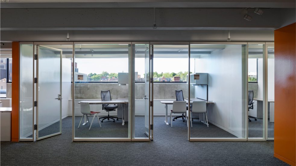 transparent office rooms and bright orange walls