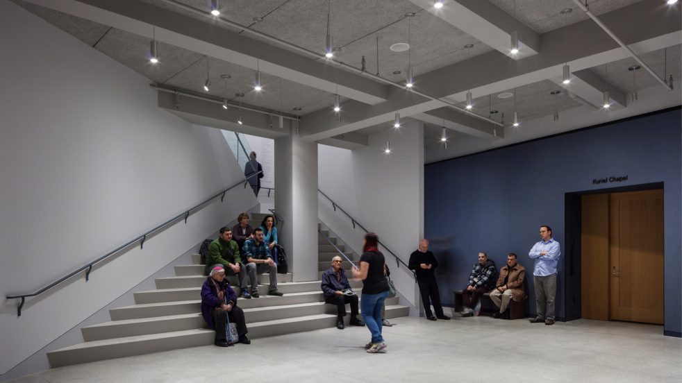 people gather on wide staircase in the CBST lower level