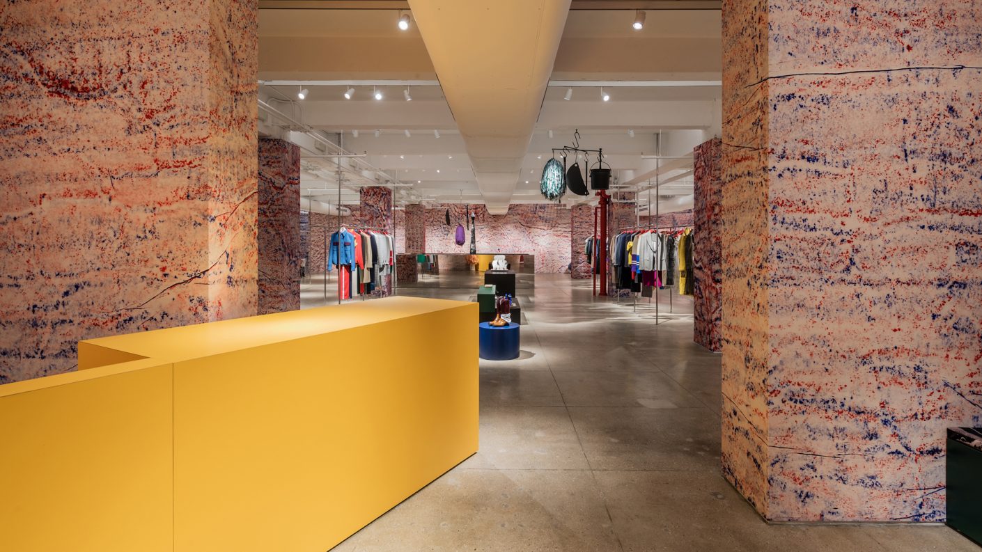 Calvin Klein showroom entry, paint splatteres walls, and yellow front desk