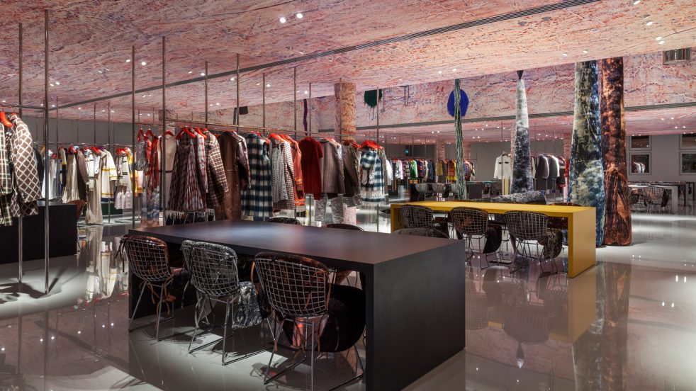 tables and chairs, Calvin Klein collection, and Sterling Ruby artwork in Paris showroom