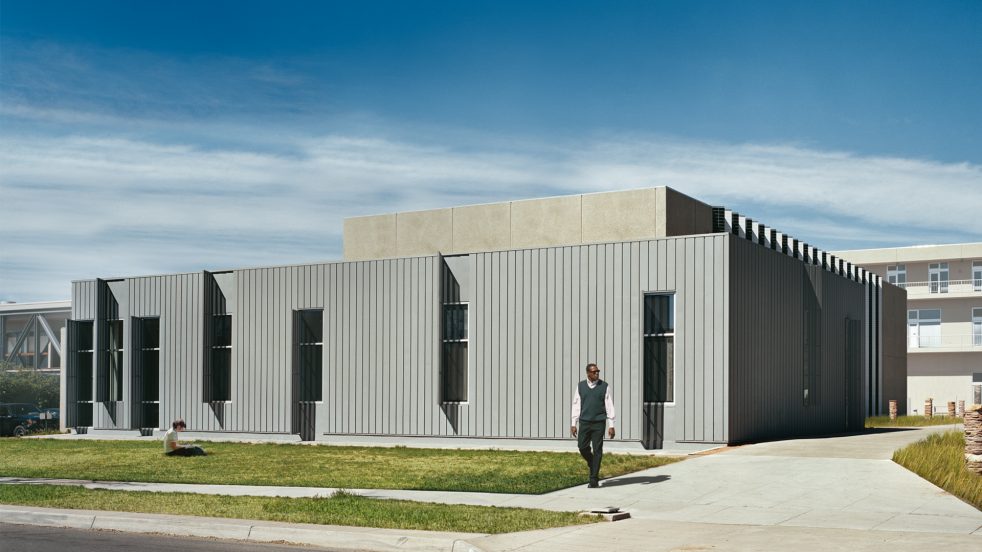 students outside the zinc panel facade on a sunny day