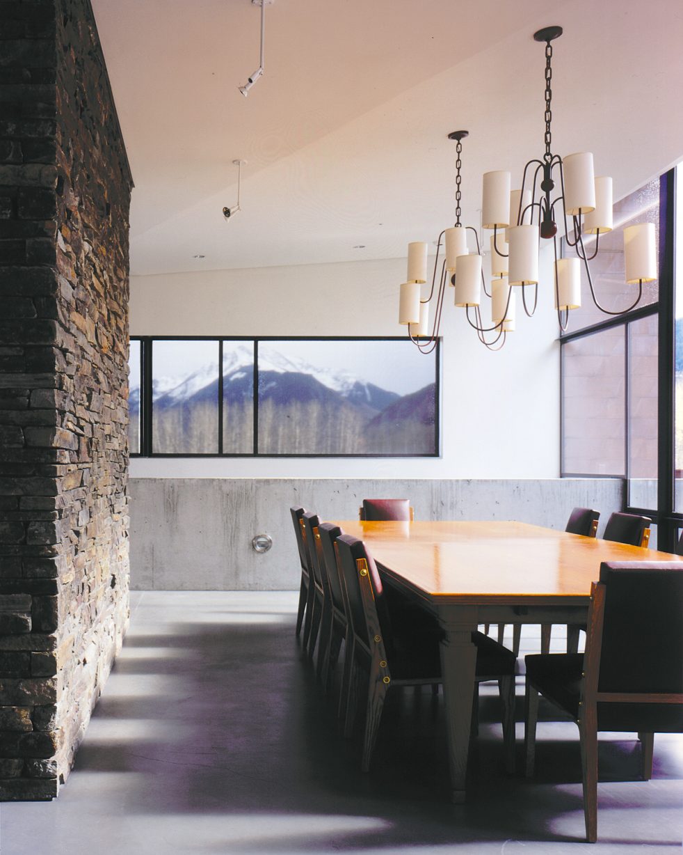 dining room, table, and chandelier near stone wall and views to the surrounding mountains