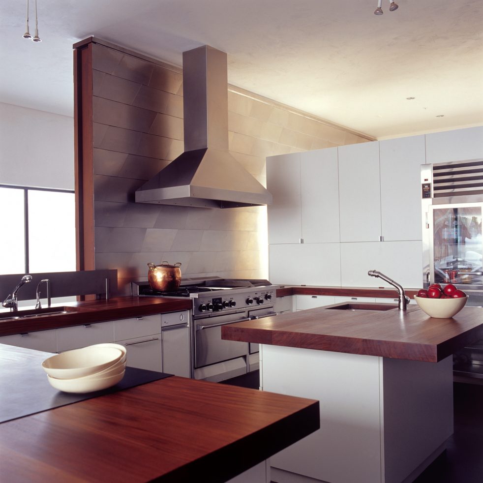 steel wall intersects modern kitchen