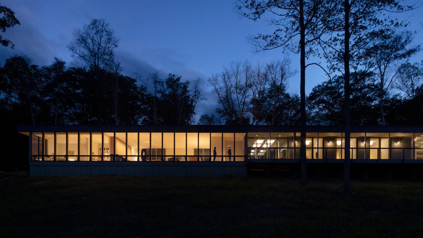 elevation view of connecticut house on a ridge, illuminated at night