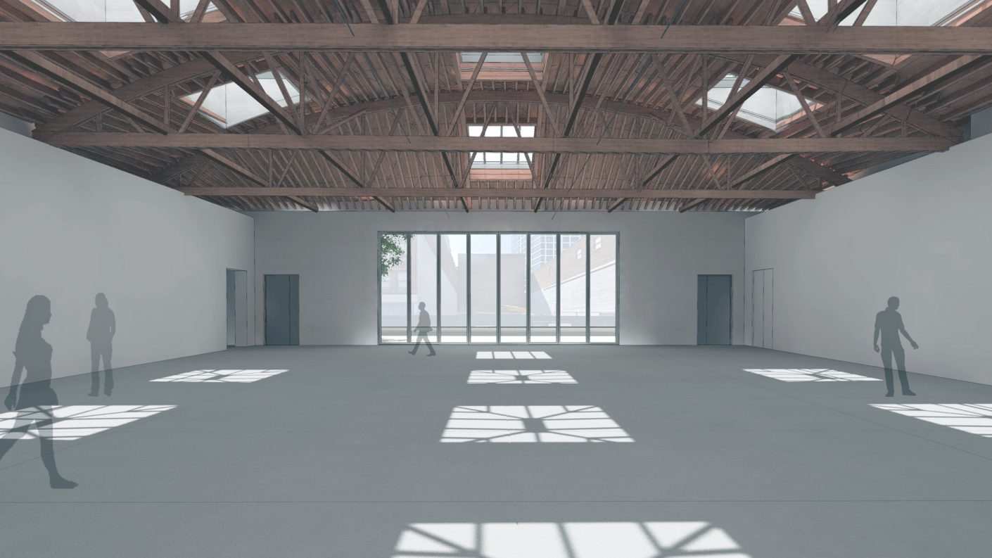 bright sunlight coming through several skylights and historic wood trusses in Dia gallery space