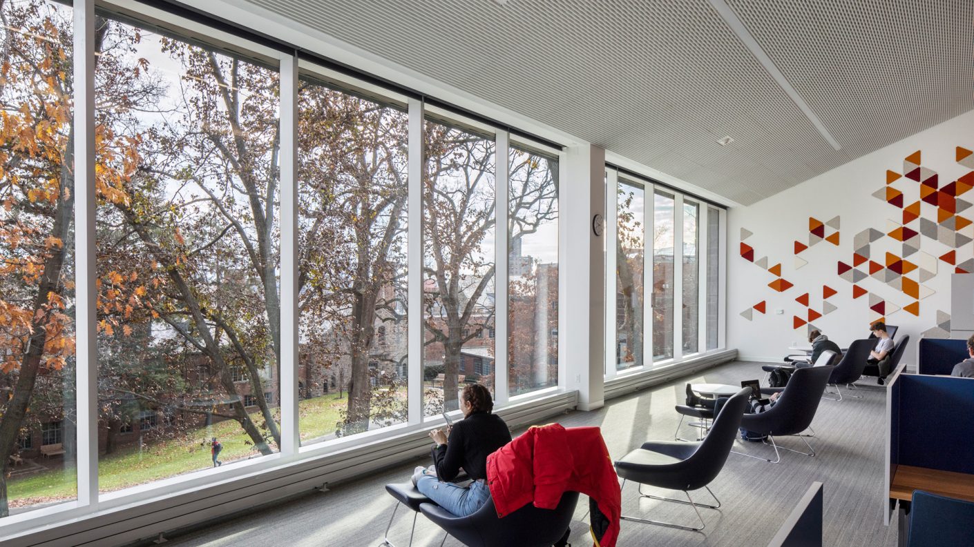 reading lounge overlooking quadrangle through floor to ceiling glass