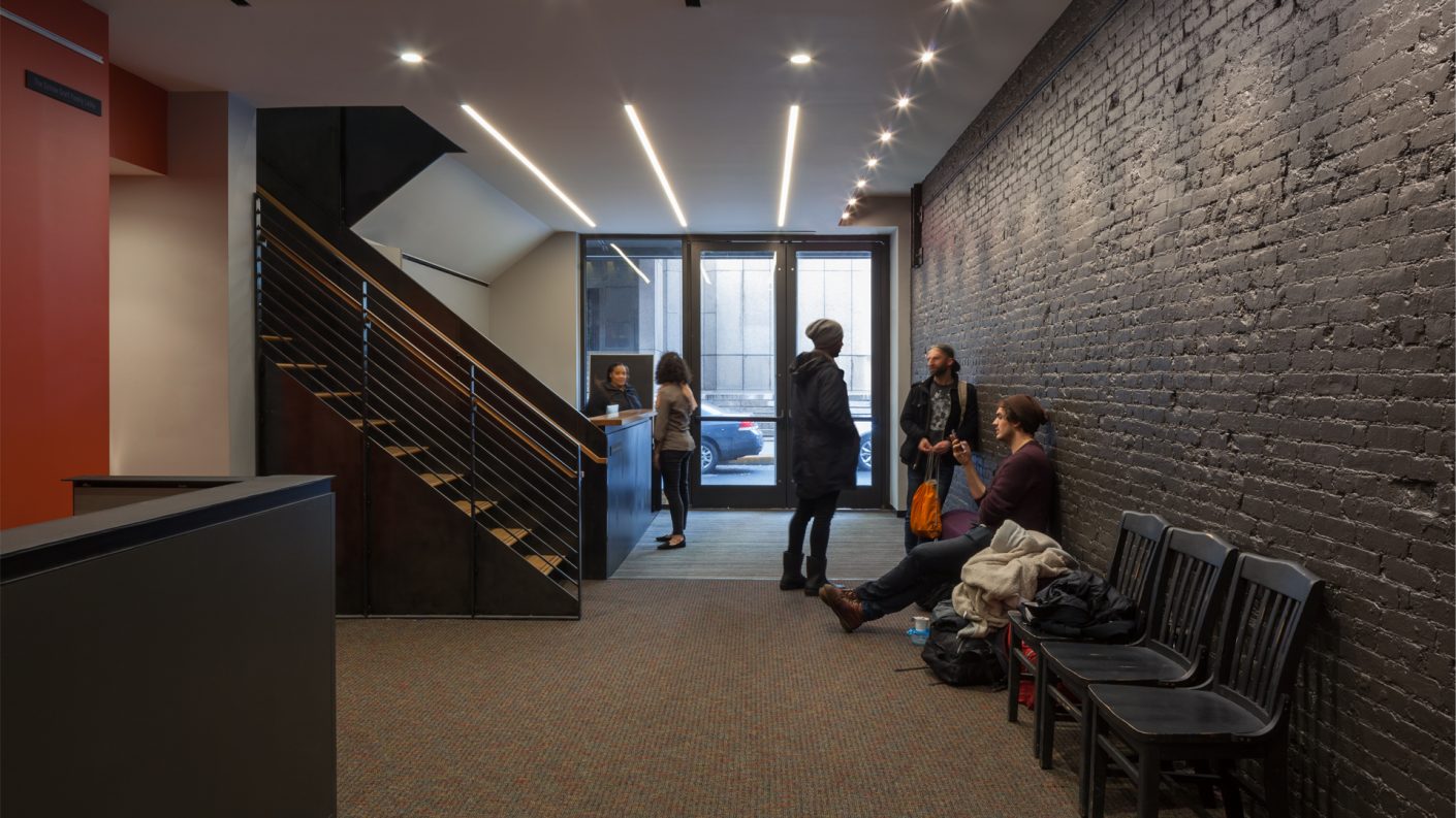 people gather in The Flea Theater lobby