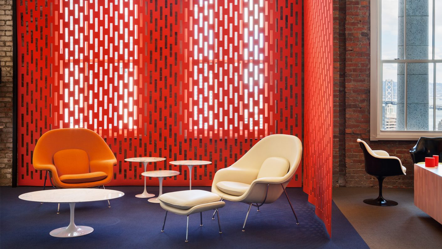 orange ARO Array, a cut acoustic felt screen separating two lounge spaces