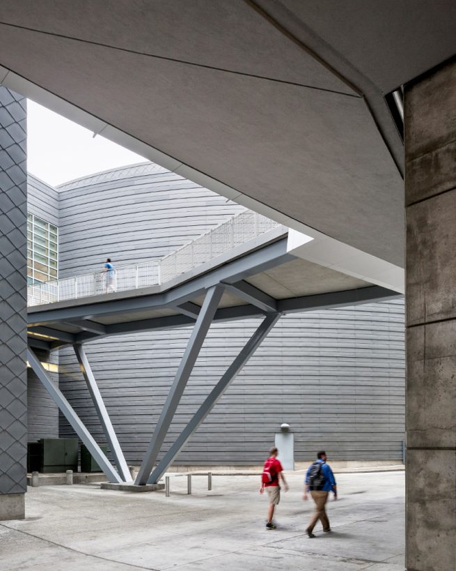 people pass under walkway connecting to student center