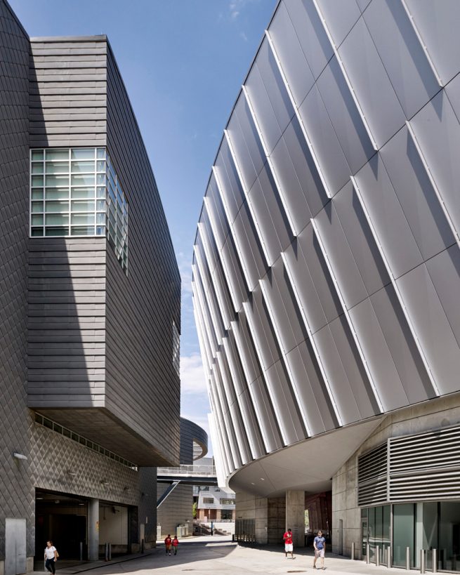 people walk between the student center and stadium