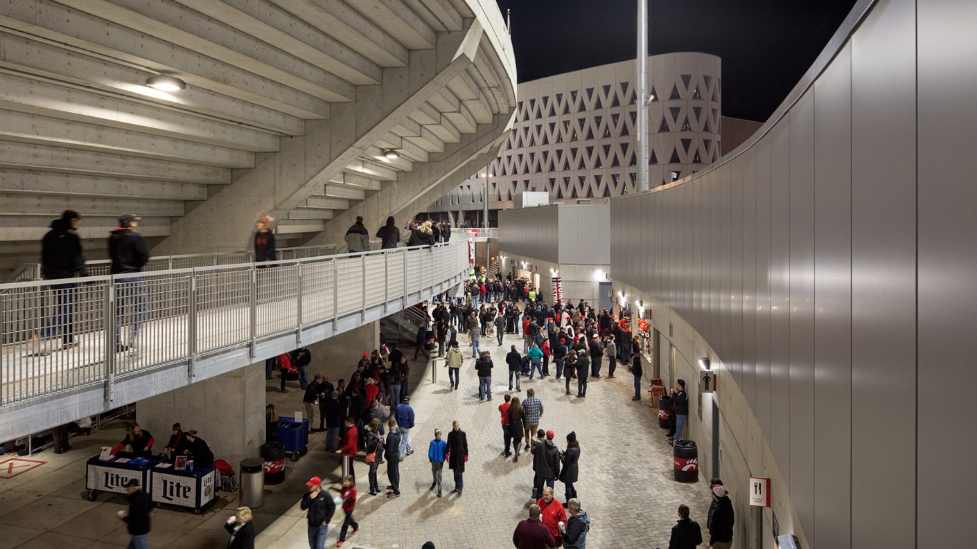 people walk through stadium concourses
