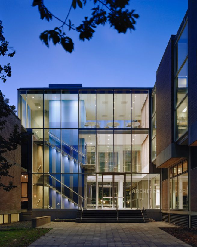 transparent School of Architecture entry illuminated at night