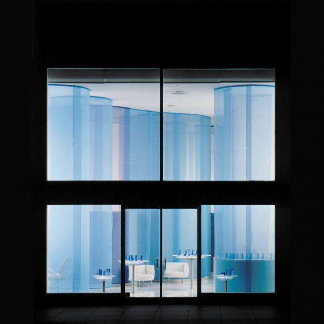 Qiora storefront shining blue at night