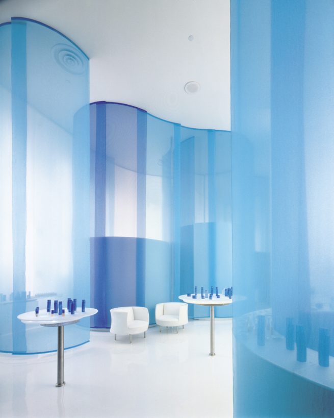Qiora retail space surrounded by blue organza space dividers