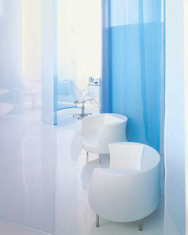 Qiora spa treatment area hidden by blue organza divider