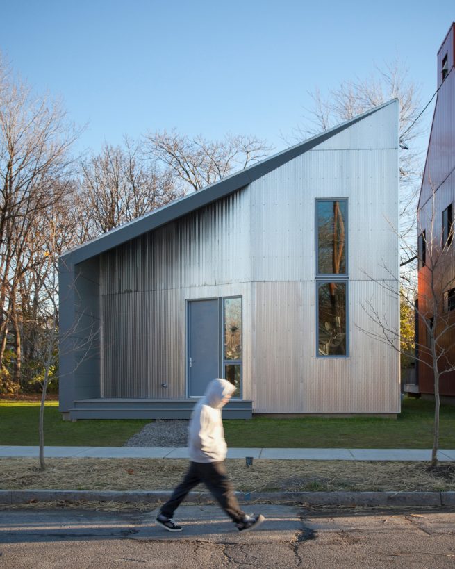 man passes in front of R-House, the passive house