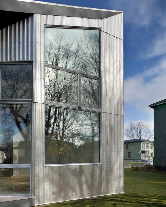 large rear window and metallic façade from outside the passive house