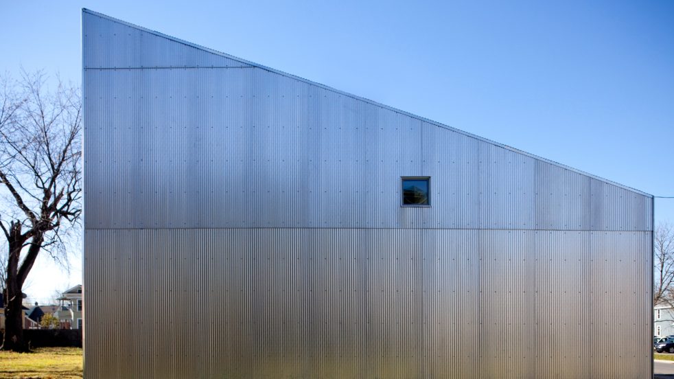 small rectangular window on geometric façade of R-house