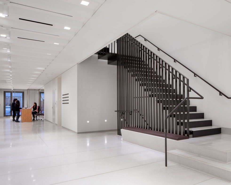 visitors at front desk near staircase