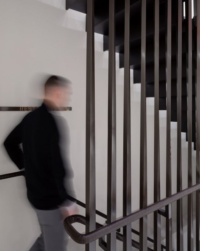 man begins to descend staircase