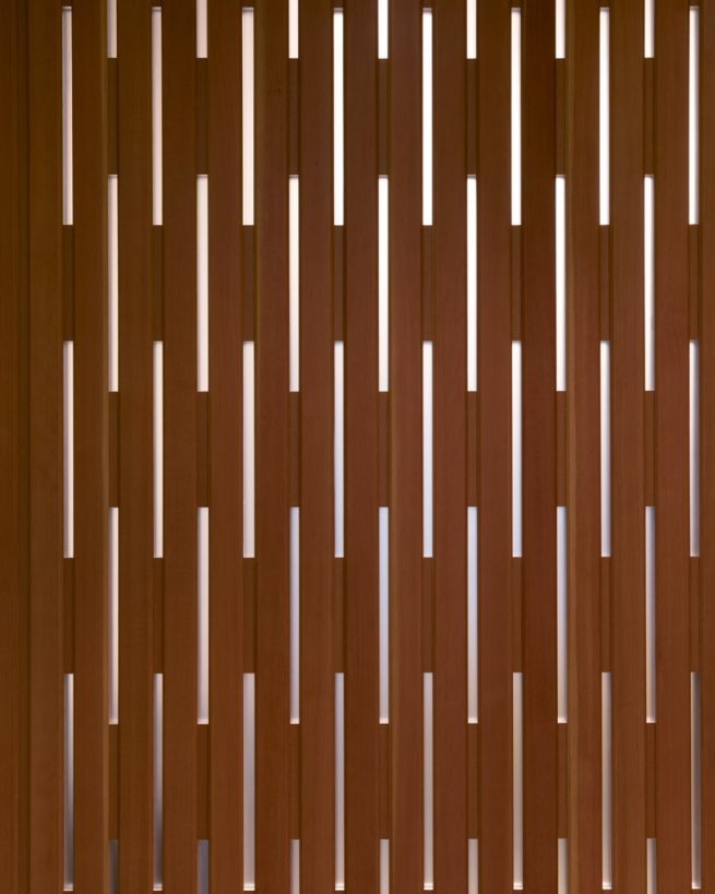 wooden wall perforated with repeating slits