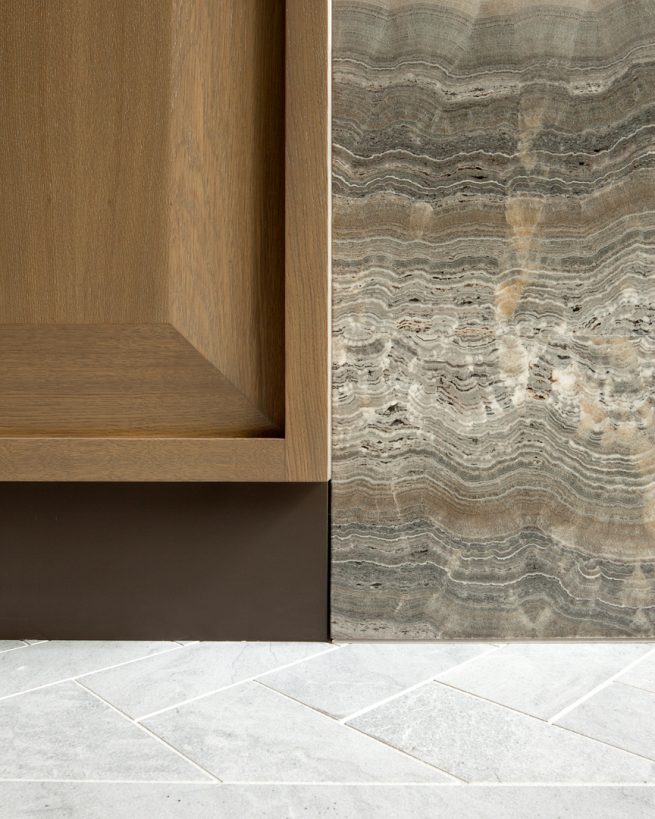 detail of wood cabinet meeting granite wall