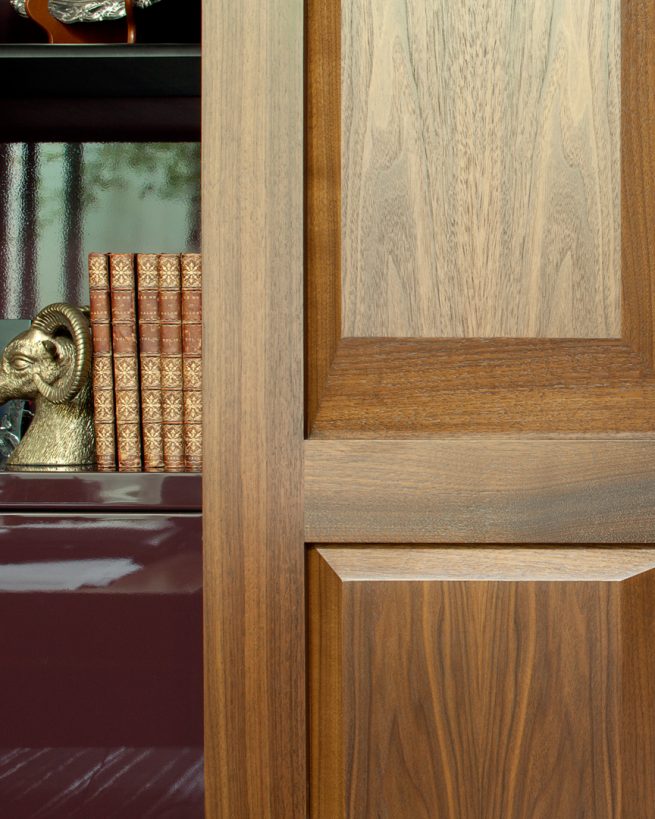 detail of wood cabinet next to bookcase