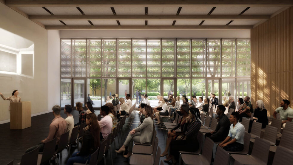 Rendering of visitors watching a presentation in the program center with views out to the courtyard