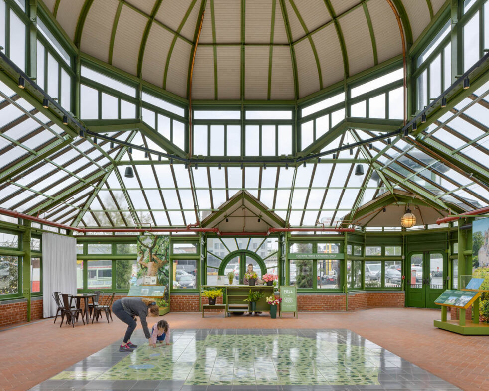 Parent and child inside a restored historic green-house