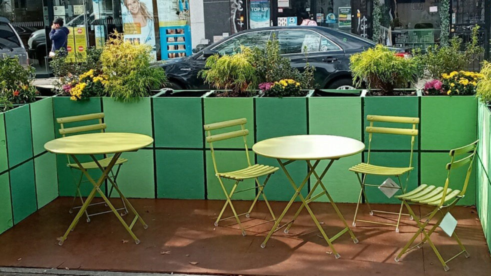 The completed outdoor seating area for Barco De Papel, with chairs, tables, and plants