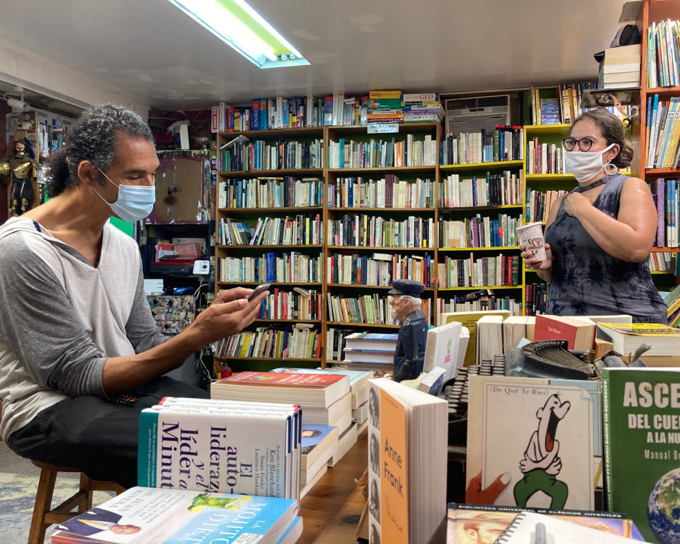 Owner Paula Ortiz and a customer inside the bookstore, Barco de Papel