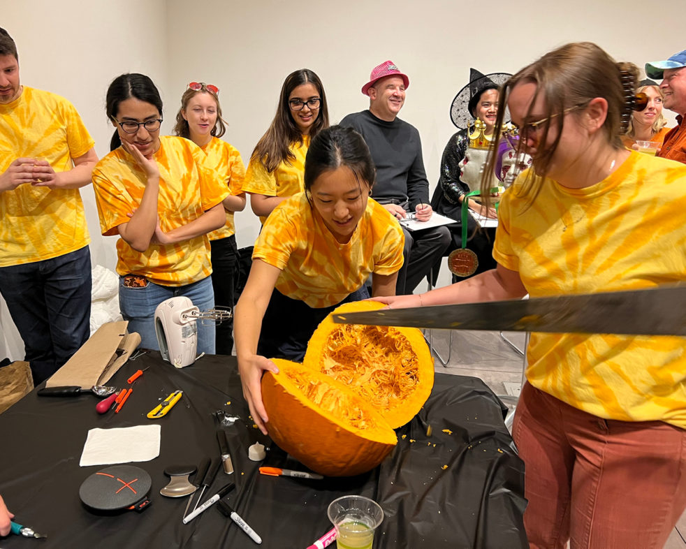 ARO's Pumpkitecture team sawing open a pumpkin