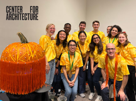 ARO's Pumpkitecture tream poses with their winning pumpkin in matching tie-dye shirts