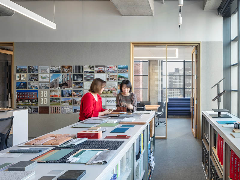 Photo of two people looking at material samples in a daylit office