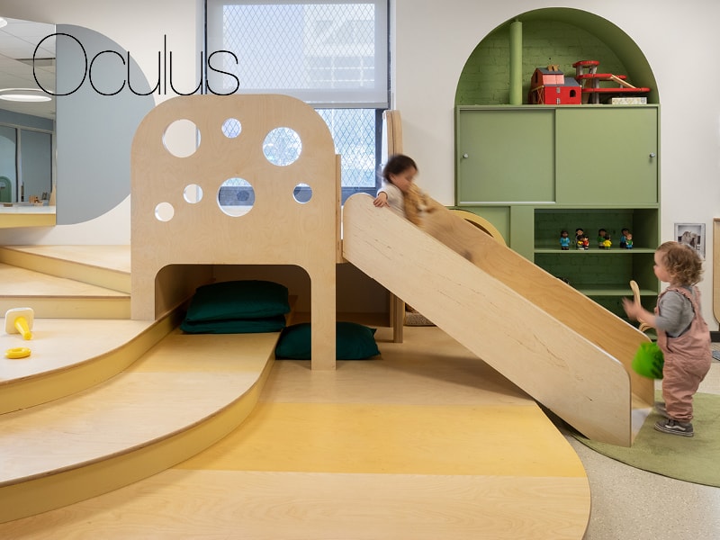 Photo of two toddlers playing on a slide