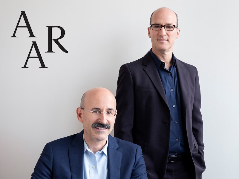 Portrait of Stephen Cassell and Adam Yarinsky against a white background