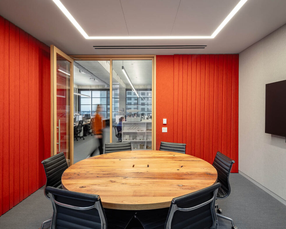 Table and chairs in an empty orange conference room