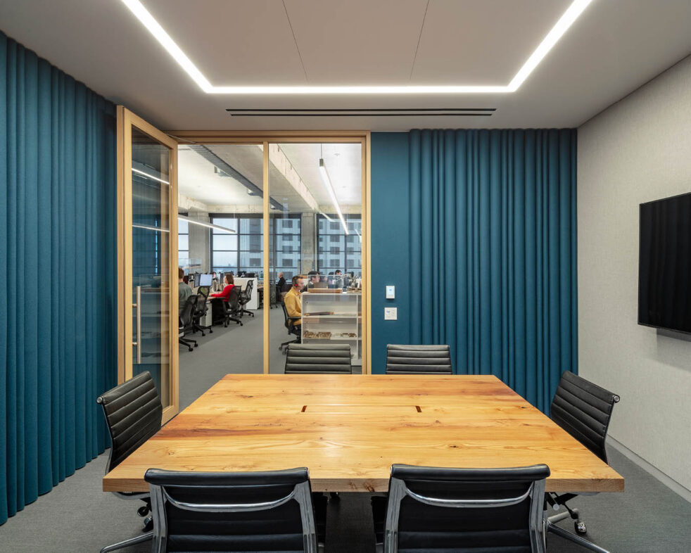 Table and chairs in an empty blue conference room