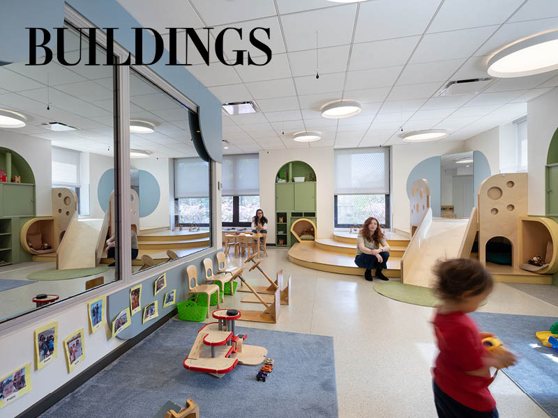 Photograph of a toddler and two adult teachers in a playroom