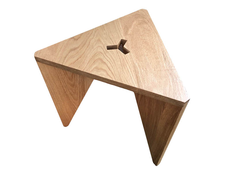 Photograph of a triangular, wooden stool