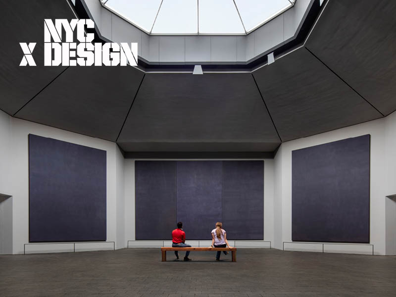 Photograph of two people sitting under a skylight looking at large paintings.