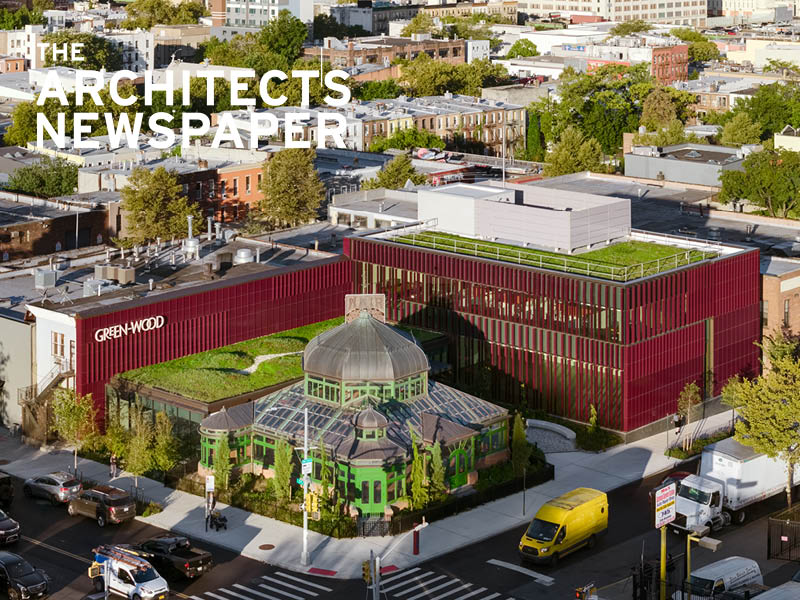 Aerial view of a historic greenhouse and a new burgundy, terra cotta-clad visitor's center. Image Credit: Rafael Gamo.