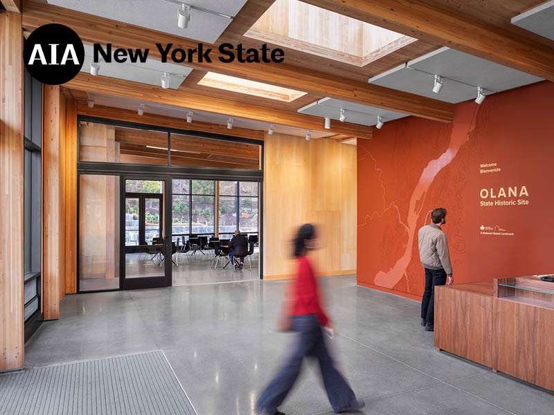people stand within the lobby of a mass timber building