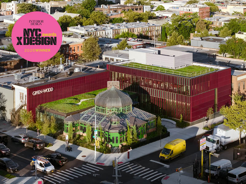 Aerial of a historic greenhouse and burgundy, terra cotta-clad visitor's center